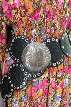 boho belt with black and silver design on a colorful floral background