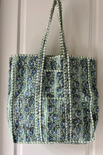 Floral patterned tote bag with green and blue boho design on a plain background