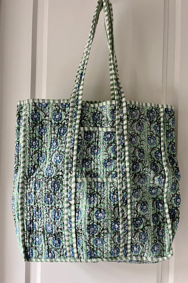 Floral patterned tote bag with green and blue boho design on a plain background