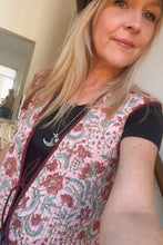 Woman wearing a boho patterned vest indoors