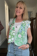 A woman wearing a green boho patchwork cotton vest