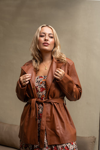 Women in wearing boho vintage inspired jacket zoom in.