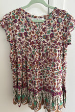 Folded floral-patterned shirt on a white background