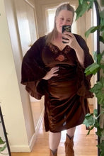 Person wearing a brown velvet boho dress with a matching shawl indoors.