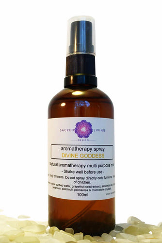 A bottle of 'Divine Goddess' essential oil blend by Sacred Living Design, with a spray nozzle, set against a white background.