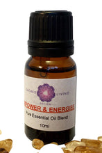 A bottle of 'Essential Oil Blend' with a label that reads 'Power & Energy' and a small crystal figure beside it, on a white background.