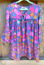 Floral dress with colorful pattern on a wooden background