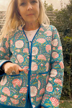 Woman wearing a floral patterned jacket outdoors